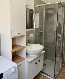 a bathroom with a sink and a shower at Lake Apartment Ischia Red, Lago di Caldonazzo in Tenna  +27 photos