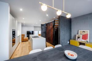 a kitchen and living room with a table and chairs at Free Parking - Roof Terrace - Luxury Townhouse in Manchester