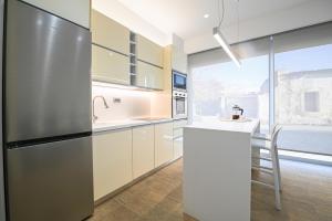 a kitchen with a refrigerator and a sink at Michelangelo City Luxury Lodge in Kos Town