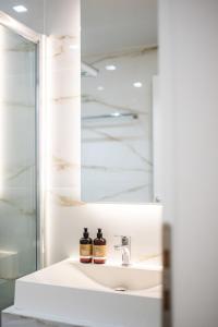 a bathroom with a sink and a mirror at Michelangelo City Luxury Lodge in Kos Town +61 photos