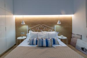 a bedroom with a large bed with two tables at Michelangelo City Luxury Lodge in Kos Town