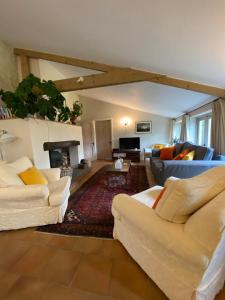 a living room with two couches and a fireplace at The Long Barn in Baltonsborough