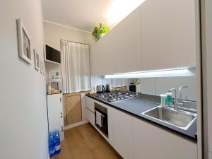 a kitchen with a sink and a stove top oven at Relax in Milano - Ventura - Lambrate - Città Studi in Milan
