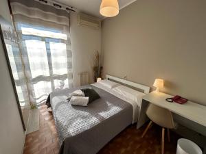 een slaapkamer met een bed, een bureau en een raam bij Hotel Miura in Cavalcaselle