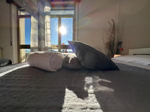 two pillows sitting on a bed in a bedroom at Hotel Miura in Cavalcaselle