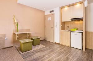 a kitchen with a counter and a sink and a table at Bed & Breakfast Park Gate in Vranje