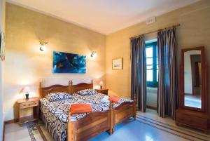 Postel nebo postele na pokoji v ubytování Djar Ta Menzja 3 Holiday Home + 14 fotografií