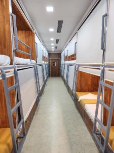 a corridor of bunk beds in a dorm room at SAHIL AC DORMITORY in Navi Mumbai