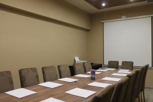 a conference room with a long table and chairs at Bed & Breakfast Park Gate in Vranje