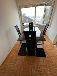 a dining room table and chairs in a room with a window at Castle View Big Appartment Vaduz Center in Vaduz