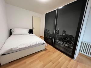 a bedroom with a white bed and a large window at Castle View Big Appartment Vaduz Center in Vaduz