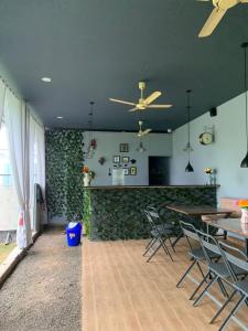a living room with tables and chairs and a wall at Hotel Rukmini Residency, Kolhapur in Kolhapur