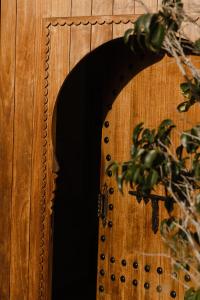 una puerta de madera con un espejo en una pared de madera en Dar Tanja Boutique Hotel, en Tánger
