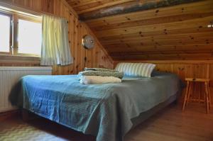 1 dormitorio con 1 cama en una habitación de madera en Villa Franca Maria en Rättvik
