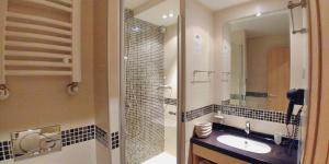 a bathroom with a sink and a shower and a mirror at Angella KOP Konaci in Kopaonik +22 photos
