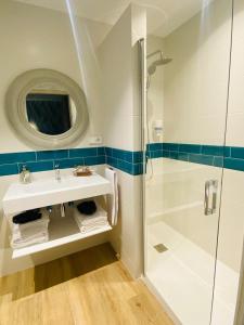 a bathroom with a sink and a shower at El Pueblín del Pinar in Navia