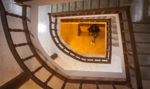 an overhead view of a person walking down a spiral staircase at Hotel Central Santa Maria in Santa Maria