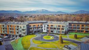 an aerial view of buildings with mountains in the background at Apartament Szafirowy in Zarzecze