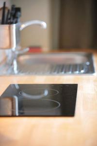 a kitchen counter with a sink and a counter top with a counter top at Cosy Chic Studio in King's Cross in London