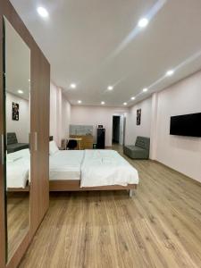 a bedroom with a large bed and a tv at Aspire Saigon - Ly Tu Trong in Ho Chi Minh City +20 photos