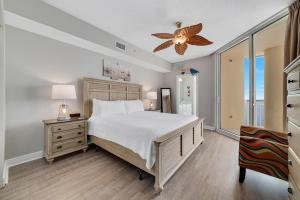 a bedroom with a bed and a ceiling fan at Beach Colony East 15C-Penthouse in Perdido Key +33 photos