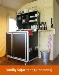 a kitchen with a small refrigerator in a room at Safari Retreat "Explorer Tents" in Holten