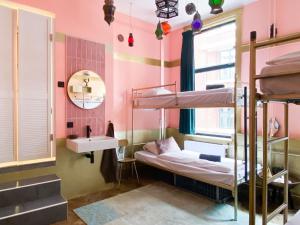 a room with two bunk beds and a sink at Hostel ROOM Rotterdam in Rotterdam