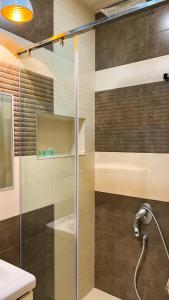 a shower with a glass door in a bathroom at Новая квартира у Площади in Yerevan +14 photos