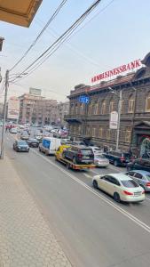 a busy city street filled with cars and buildings at Новая квартира у Площади in Yerevan