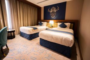 Postel nebo postele na pokoji v ubytování Najm aris hotel