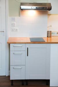 a kitchen with a counter with a stove top oven at Sunlight Studio in King's Cross in London