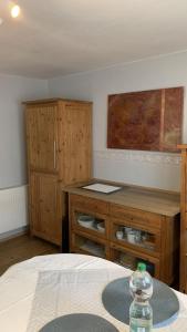 a bedroom with a desk and a table with a bottle of water at Ferienhaus Cornelia in Koblenz