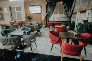 a restaurant with tables and chairs in a room at Grand Quars Hotel in Avcılar