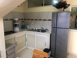a kitchen with a stainless steel refrigerator and a sink at Apartamento para 5 in Barranquilla