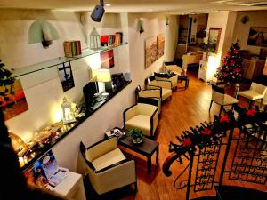 a living room with chairs and a christmas tree at Bi Hotel in Porto Ercole