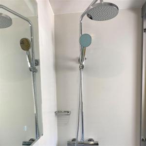 a shower in a bathroom with a mirror at Cliftonville, en-suite room, fridge microwave TV, great value homestay near the sea in Lymington