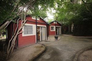 a red and white building with a garage at Camp Jonathan in Sodwana Bay