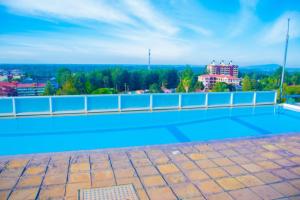 a swimming pool on the roof of a building at LaMeg2 Furnished Studio with Pool - Kiambu Rd in Nairobi