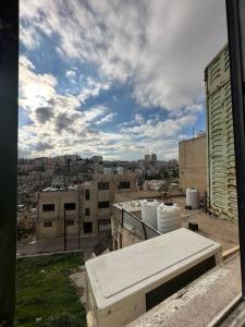 a view of a city skyline from a building at Antica old apartment al-lwebdeh in Amman
