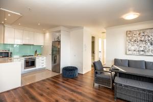 a kitchen and living room with a couch and a table at Jade Resorts Melbourne in Melbourne