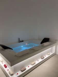 a hot tub in a white room with at Archimar House in Taranto