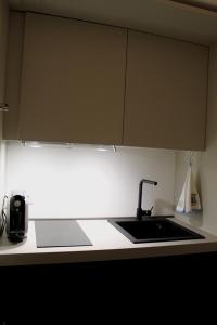 a kitchen with a sink and a counter top at Archimar House in Taranto
