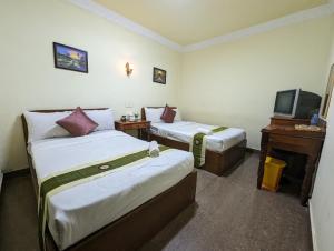 Postel nebo postele na pokoji v ubytování Reach Kunthea Guesthouse