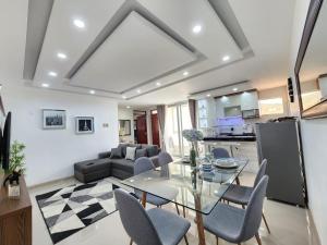 a living room with a glass table and chairs at Fresnos 891 in Huancayo