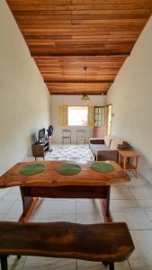 a living room with a table and a couch at Casa Sabiá - Lençóis/BA in Lençóis