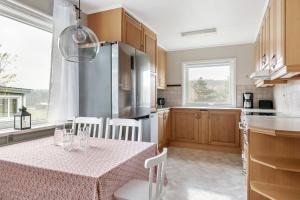 a kitchen with a table and a refrigerator at Peaceful holiday home surrounded by nature in Töllsjö