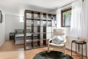 a bedroom with a book shelf and a chair and a bed at Peaceful holiday home surrounded by nature in Töllsjö