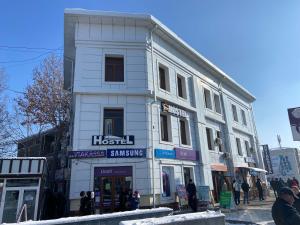 a white building on the corner of a street at Hostel Highway in Samarkand