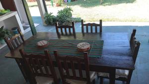 a wooden table with chairs and a table with a bowl on it at Las orquídeas in Goya