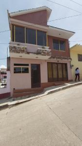 a man walking in front of a house at HOSPEDAJE 4Casa San Francisco in Zacatlán